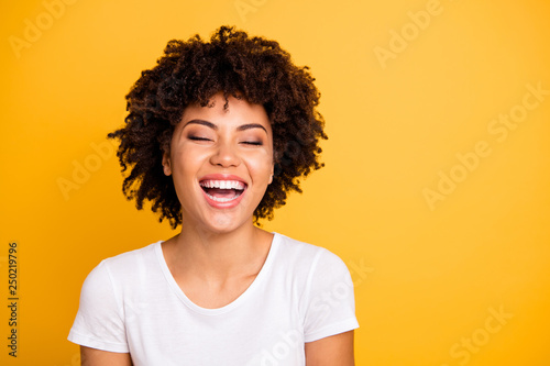 Close up photo pretty amazing she her dark skin lady scream shout of laughing funny joke humor comic story open mouth wearing casual white t-shirt isolated yellow bright vivid background