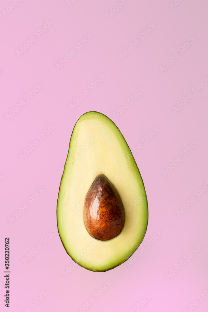 Half sliced avocado on white background.