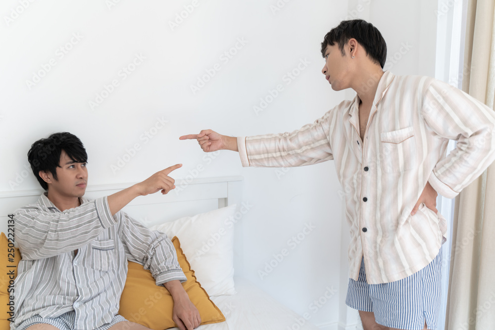 Gay couple having argument and do not take care each other in bedroom at home. Homo sexsual love concept. Gay couple having argument and do not take care each other in bedroom at home. Homo sexsual love concept.