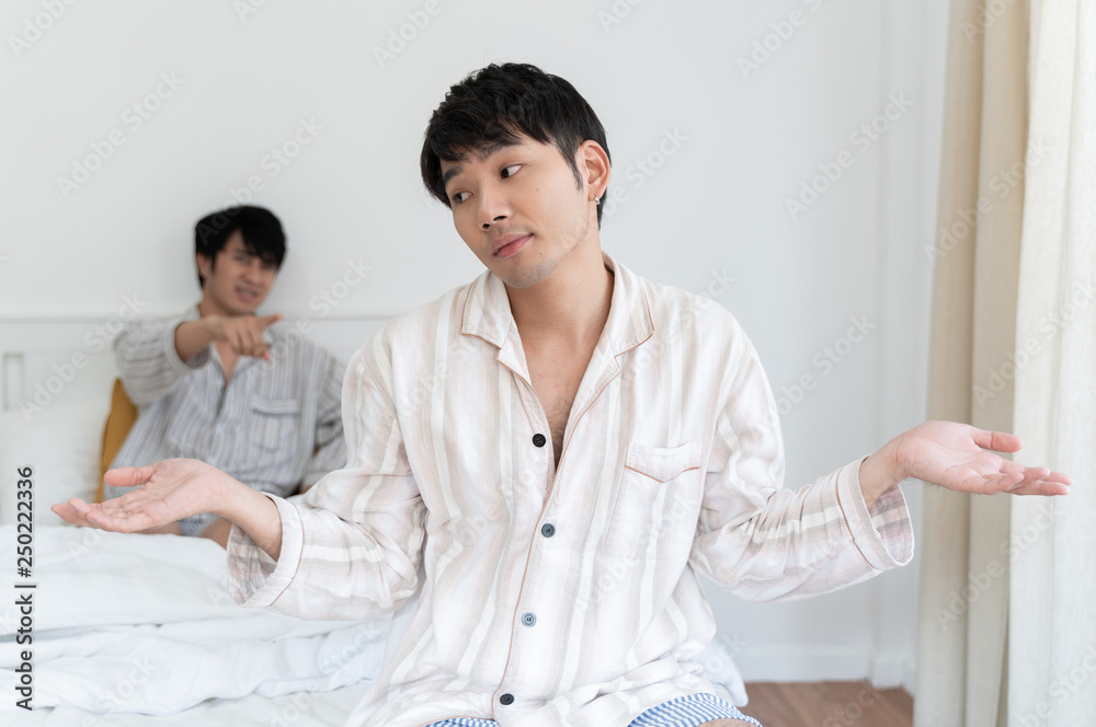 Gay couple having argument and do not take care each other in bedroom at home. Homo sexsual love concept. Gay couple having argument and do not take care each other in bedroom at home. Homo sexsual love concept.