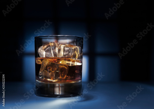 whiskey glass ice on dark beauty background,