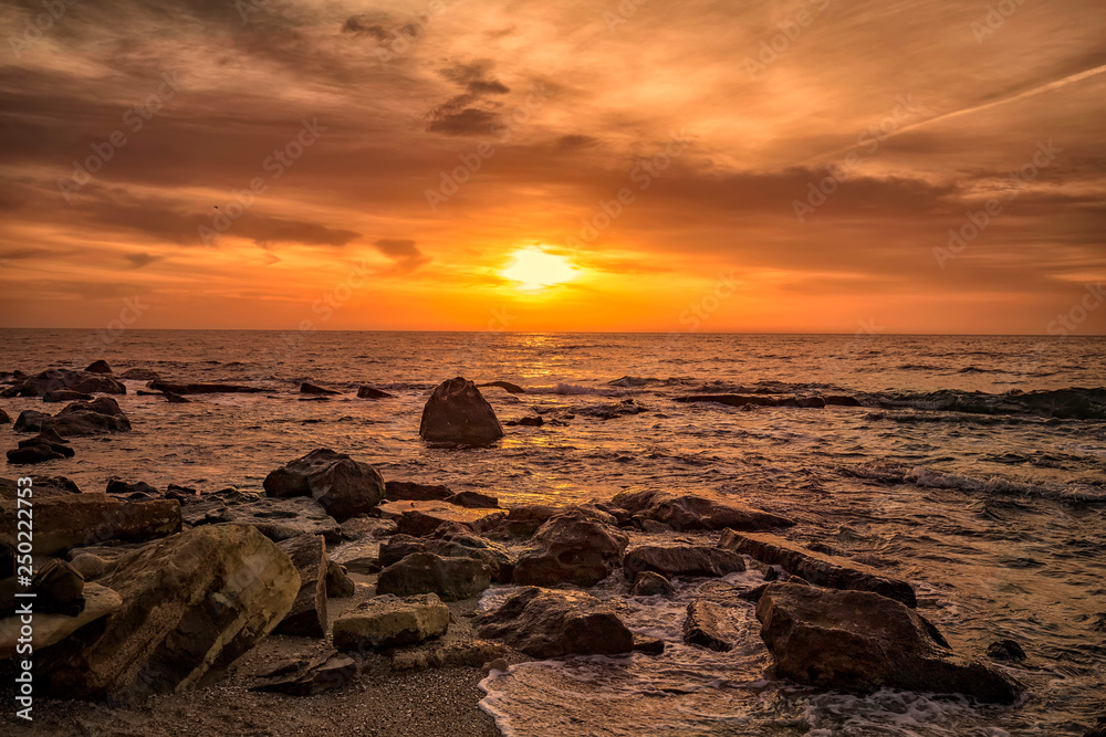 Colorful sunrise over the sea with rocky coast Colorful sunrise over the sea with rocky coast
