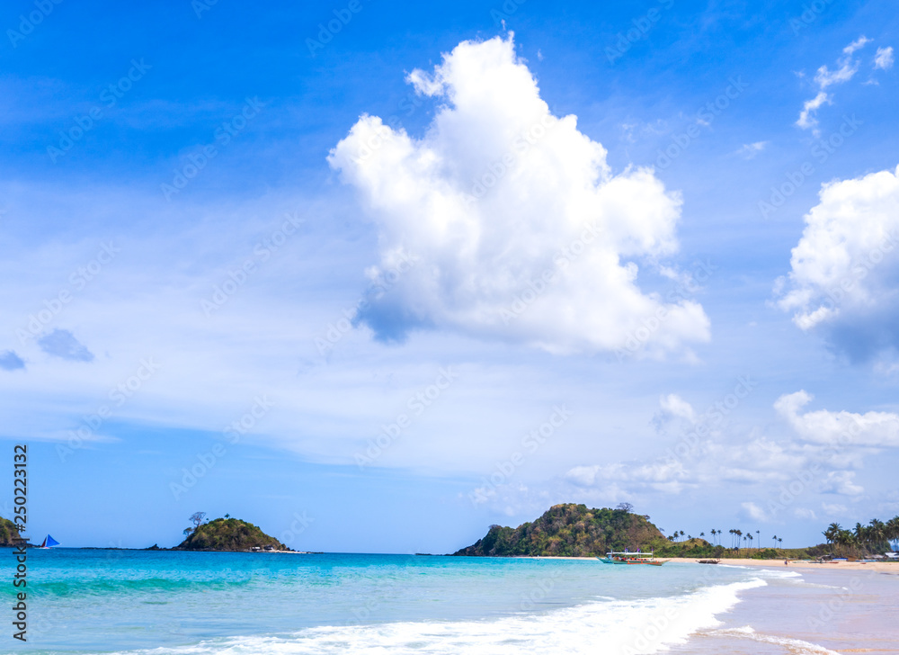 Beautiful amazing gold colored sandy beach with soft waves isolated with sunny blue sky. Concept of tropical calm tourism idea, copy space, close up Beautiful amazing gold colored sandy beach with soft waves isolated with sunny blue sky. Concept of tropical calm tourism idea, copy space, close up