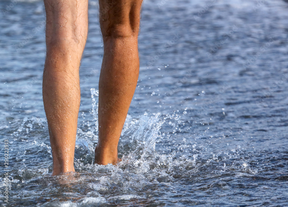 Girl's legs in the water of the sea Girl's legs in the water of the sea