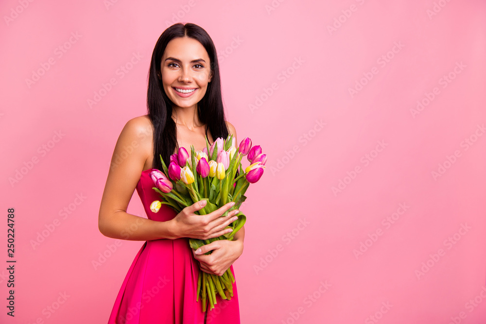 Portrait of her she nice cute attractive lovely pretty adorable fascinating charming cheerful glad positive brunette lady holding in hands colorful flowers florist isolated on pink pastel background