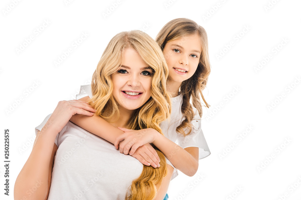 cute smiling daughter embracing mother from back isolated on white