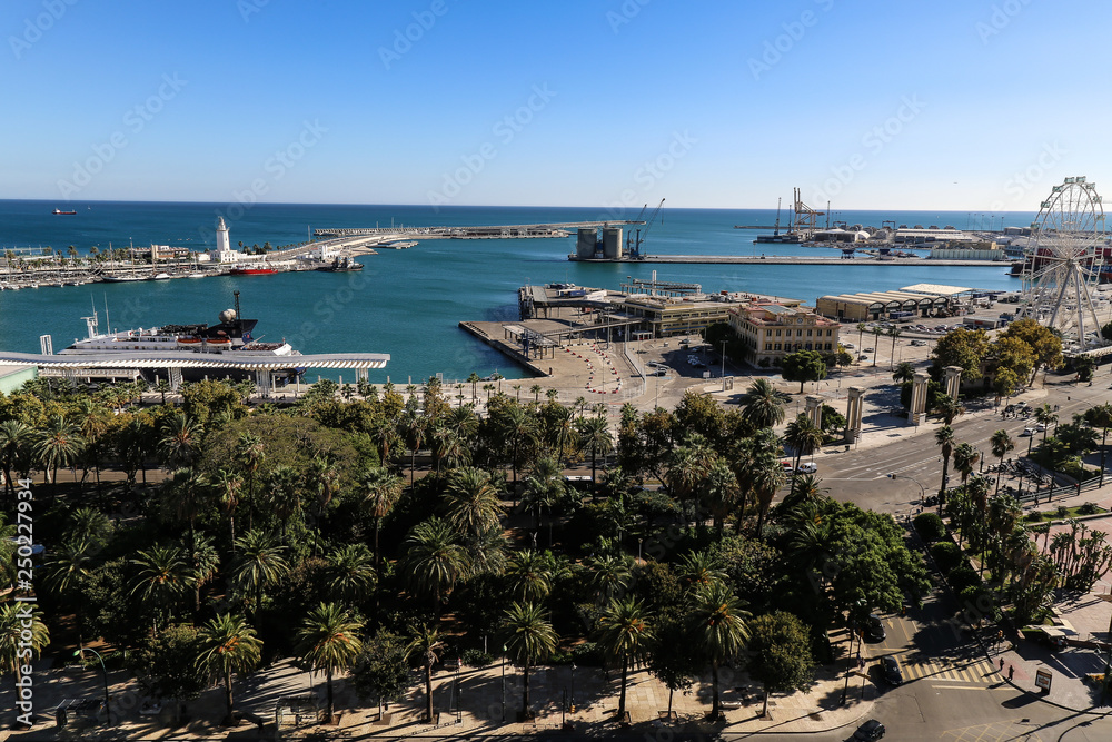 The port of Málaga with the park in the foreground and the clear blue sky in the background