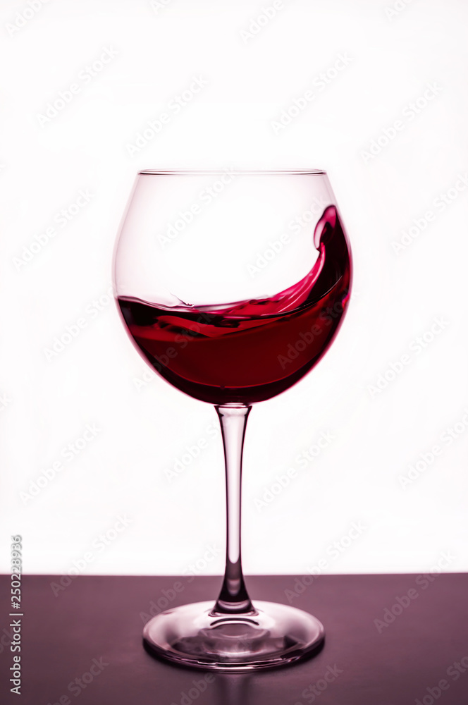 splashes of red wine in a wineglass splashes of red wine in a wineglass