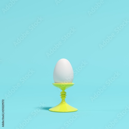 White egg on yellow dish on blue background. minimal idea concept.