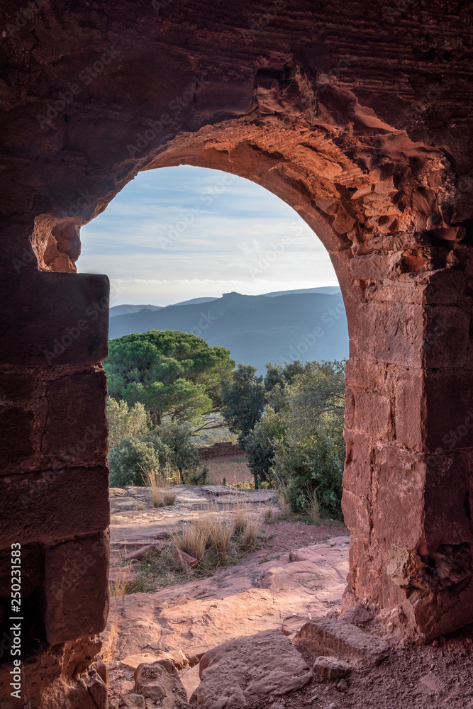View from inside a ruined castle on the mountain at sunset
