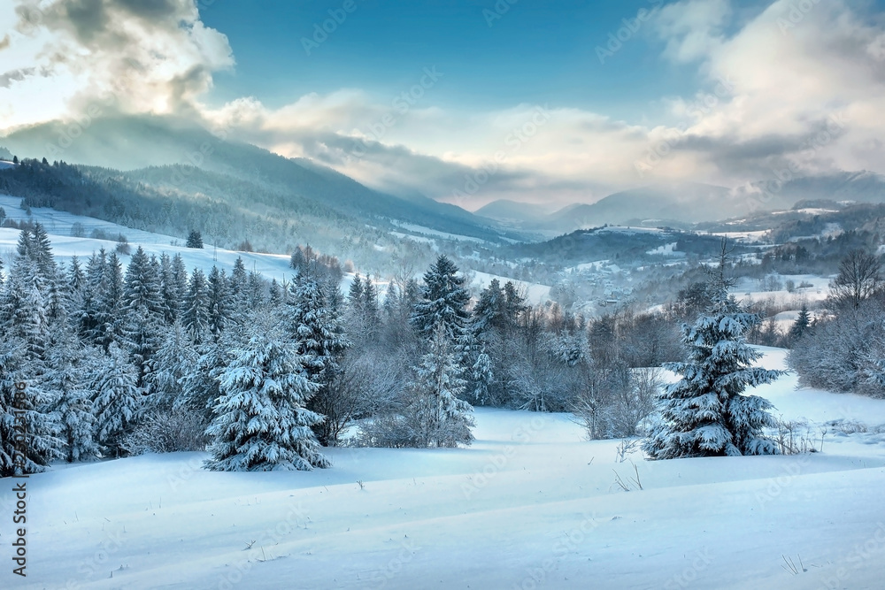 Nice mountains view in snowy sunny day under blue sky with sun l