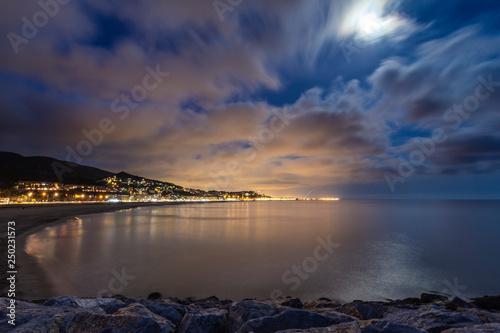Calm beach at night with spectacular sky and moon