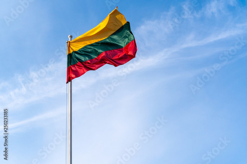 Lithuanian flag on the blue sky background photo