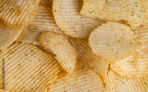 potato chips with herbs and pepper. background