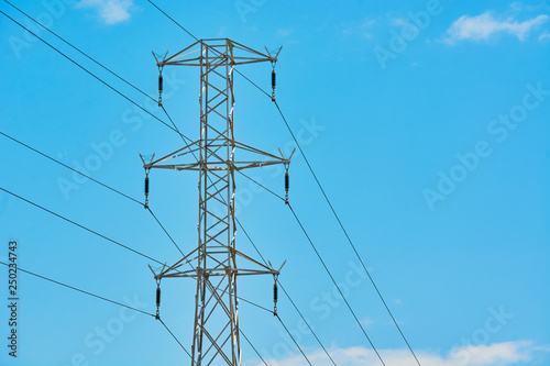 Electric transmission line with steel wires stretched against sky.