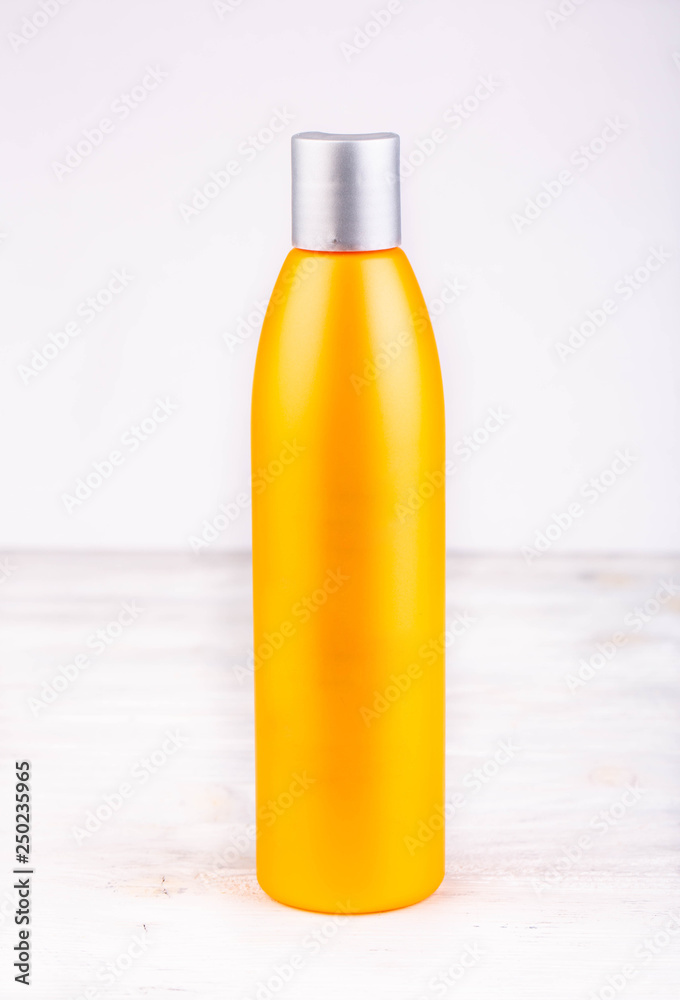 An orange bottle for liquids on a white background An orange bottle for liquids on a white background