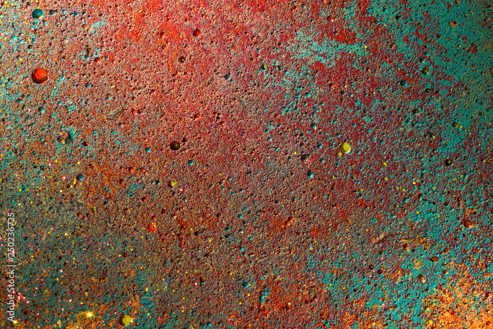 concrete detail painted with colorful yellow, green, turquoise, red. grunge wall cement texture