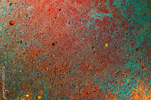 concrete detail painted with colorful yellow, green, turquoise, red. grunge wall cement texture