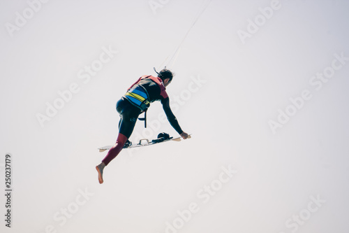 Kite surfer performing difficult tricks in high winds. Extrme sports shot in Tarifa, Andalusia, Spain