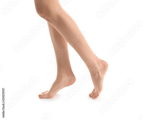 Legs of young woman with beautiful pedicure on white background