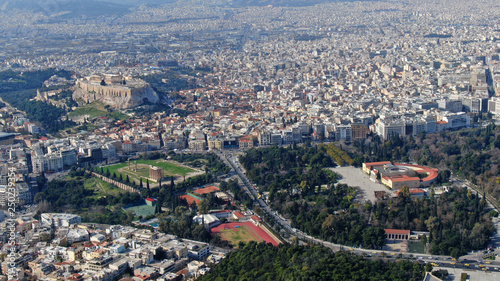 Aerial drone photo of iconic ancient Panathenaic stadium or Kalimarmaro as seen from distance and Acropolis hill, Zappeion at the background, Athens historic centre, Attica, Greece