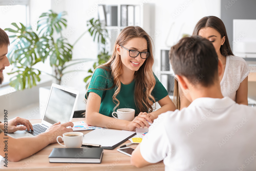 Group of people discussing business plan in office Group of people discussing business plan in office