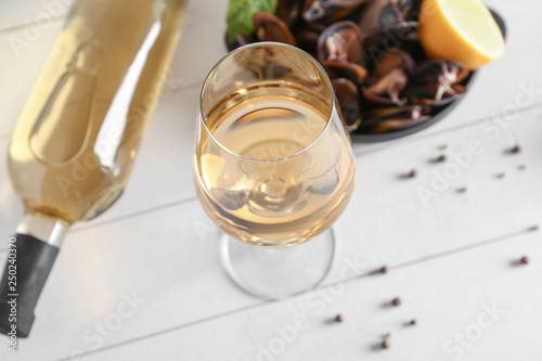 Glass of tasty wine on white table