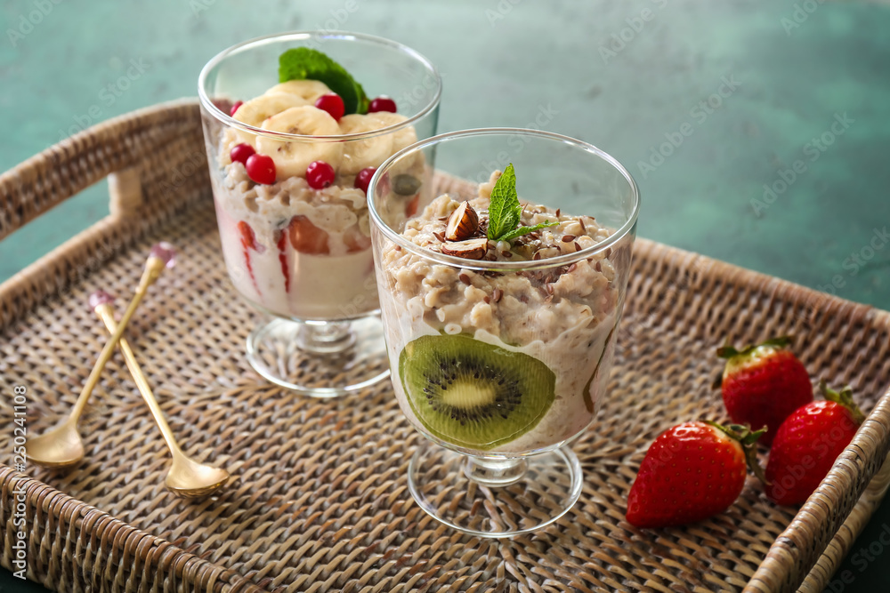 Glasses with tasty oatmeal on wicker tray Glasses with tasty oatmeal on wicker tray