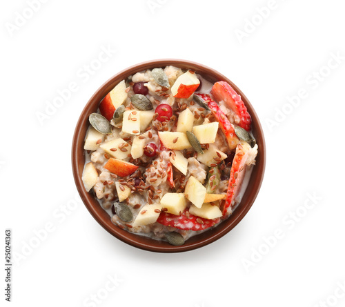 Bowl with tasty oatmeal on white background