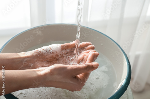 Woman washing hands at home