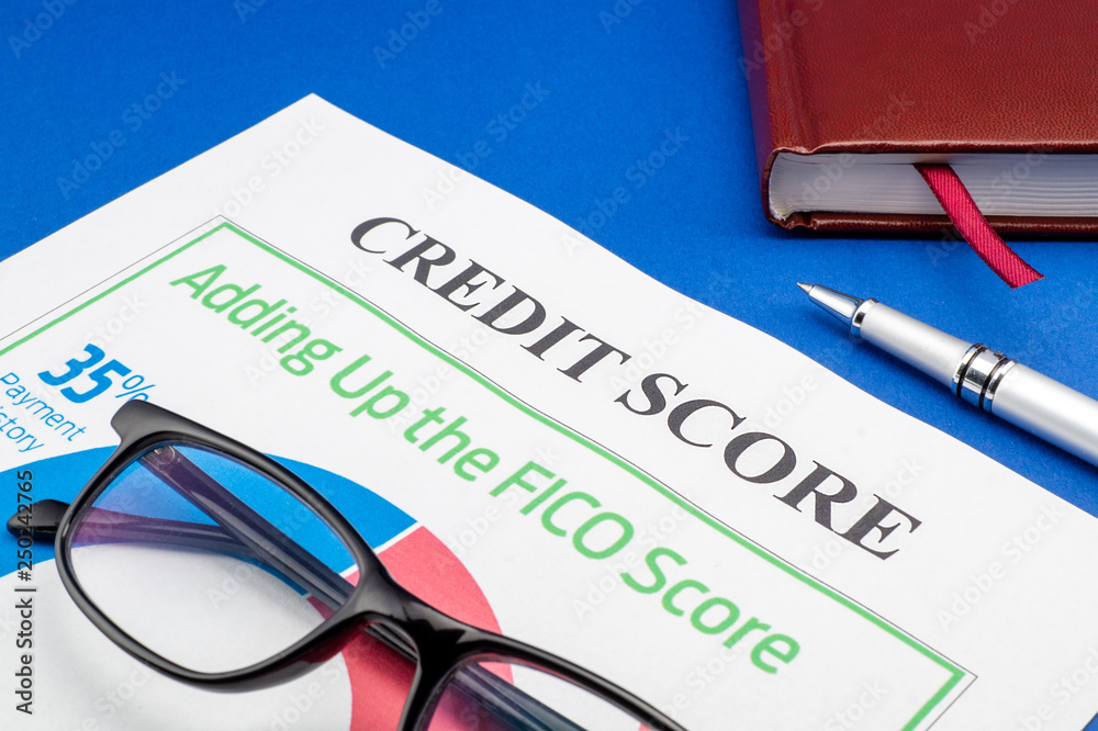 Credit score report with pen and notepad. Credit score report with pen and notepad.