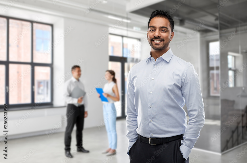 business, realty and people concept - smiling indian businessman or realtor over empty office room background business, realty and people concept - smiling indian businessman or realtor over empty office room background