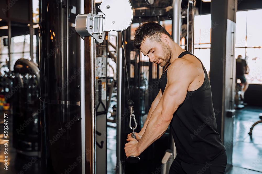 Closeup of a muscular young man lifting weights Closeup of a muscular young man lifting weights