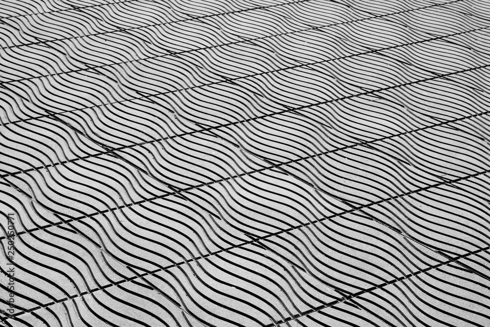 floor tiles in urban city street background - monochrome