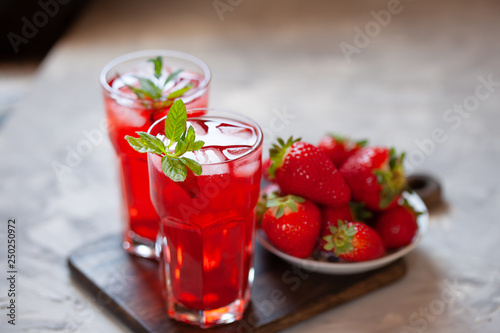 Fresh strawberry lemonade garnished with mint, copy space