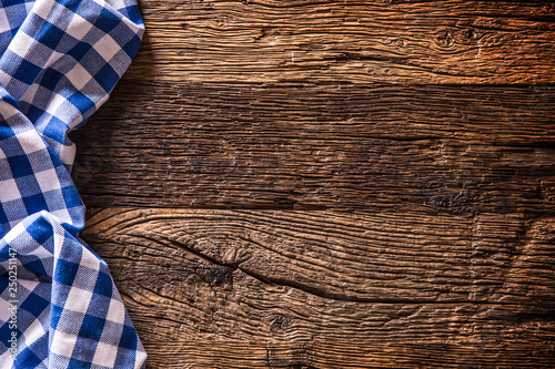 Blue checkered kitchen tablecloth on rustic wooden table