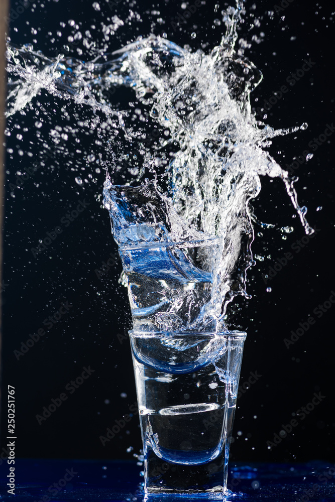 Two small glasses are beating each other on the fragments Two small glasses are beating each other on the fragments