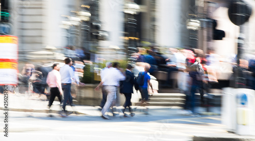 Motion blur of walking people. Modern competitive life concept. People walking next to the Bank of England wall. London, UK