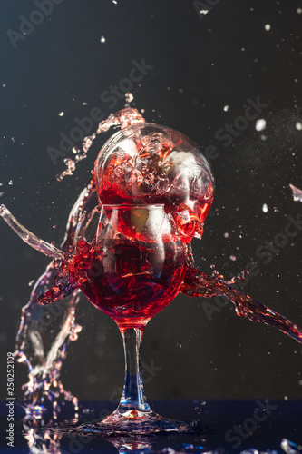 Two small glasses of wine are beaten each other on the shards