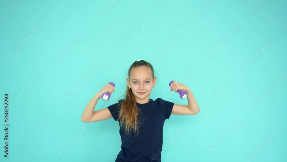 Young teenager girl lifting dumbbell at gym training on empty copyspace background. Sporty girl doing fitness exercise with dumbbell. Sport lifestyle concept Young teenager girl lifting dumbbell at gym training on empty copyspace background. Sporty girl doing fitness exercise with dumbbell. Sport lifestyle concept