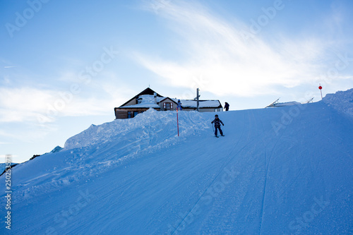 Happy people, children and adults, skiing on a sunny day in Tyrol mountains