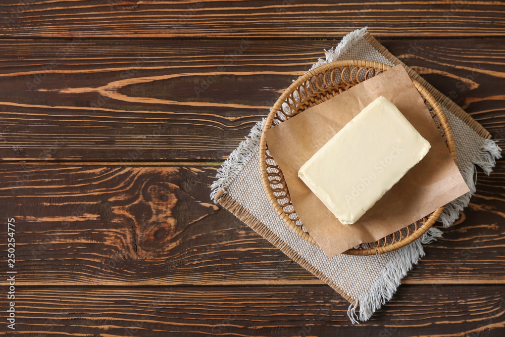 Plate with butter on wooden background Plate with butter on wooden background