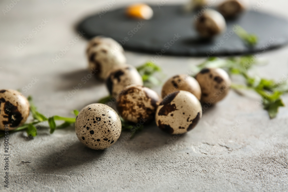 Fresh quail eggs on grey table Fresh quail eggs on grey table