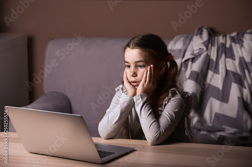 Cute little girl with lapto...