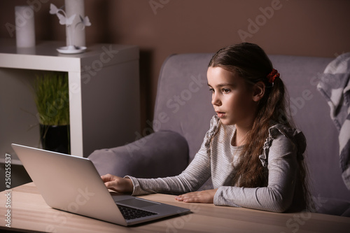 Cute little girl with lapto...