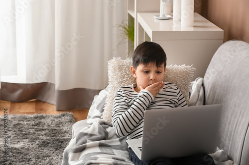 Cute little boy with laptop...