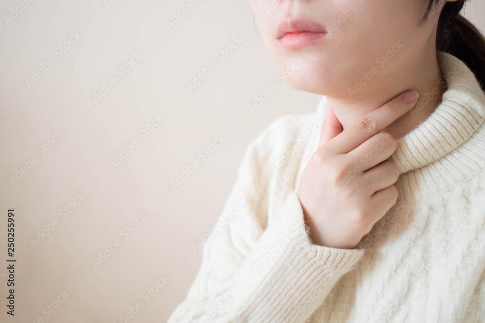 Sick women suffering from sore throat during winter season. Causes of throat pain include flu, common cold, respiratory tract infections or allergies. Close up. Copy space. Health/medical concept. Sick women suffering from sore throat during winter season. Causes of throat pain include flu, common cold, respiratory tract infections or allergies. Close up. Copy space. Health/medical concept.