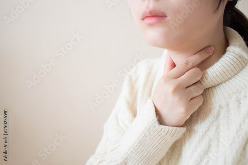 Fototapeta Sick women suffering from sore throat during winter season