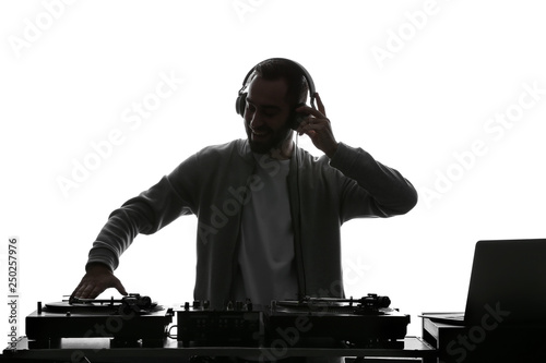 Silhouette of male DJ playing music on white background