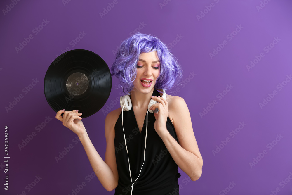 Beautiful young woman with vinyl disk and headphones on color background - obrazy, fototapety, plakaty 